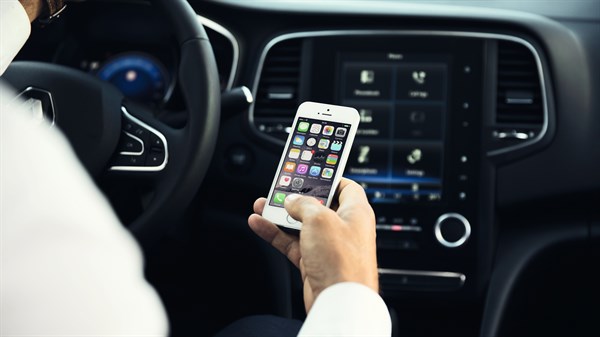 Renault MEGANE Sedan - Man looking at his smartphone